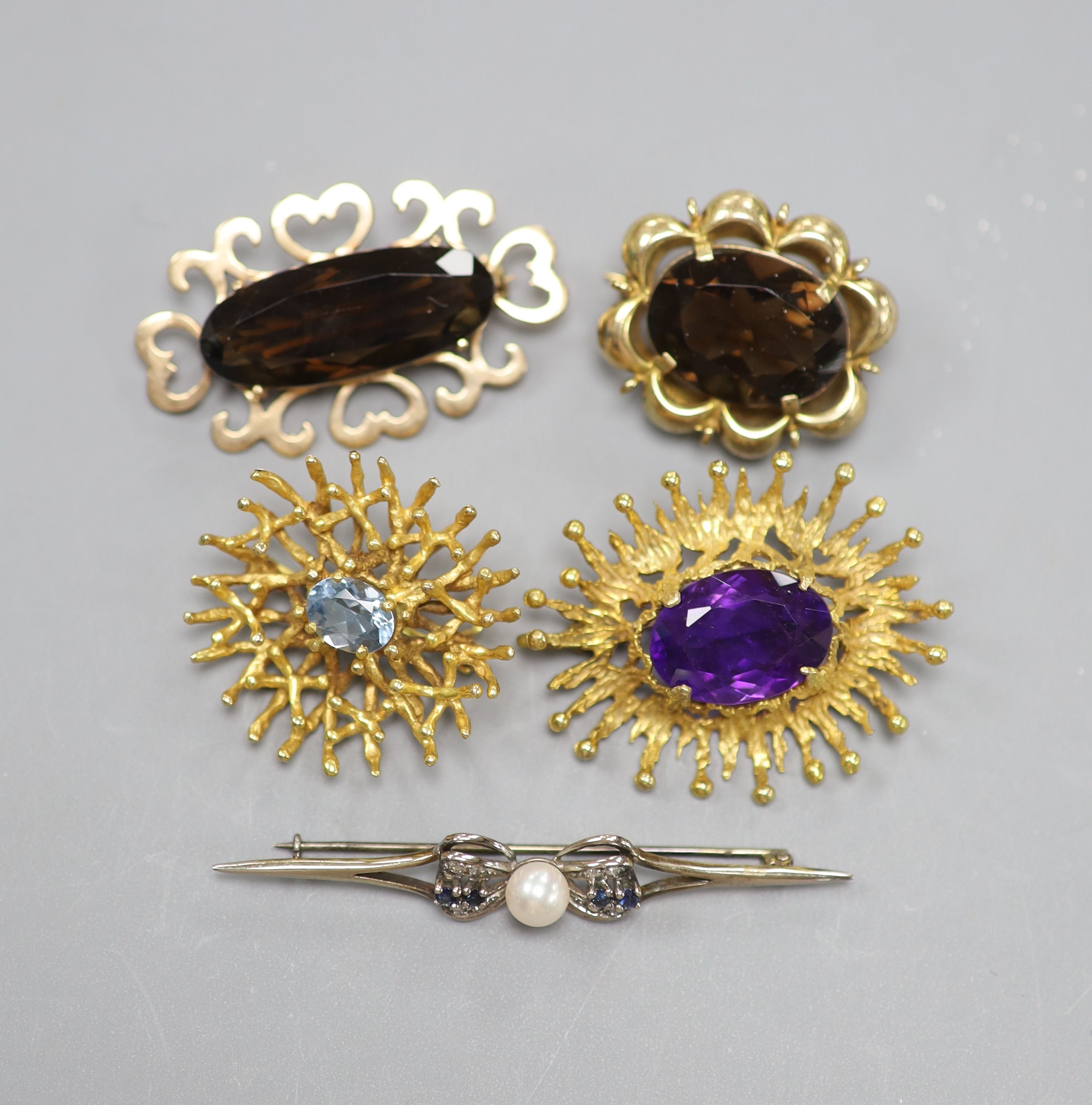 A modern 9ct white metal, sapphire, diamond and cultured pearl set bar brooch, 61mm and four other modern 9ct gold and gem set brooches, including amethyst and smoky quartz